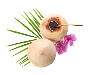 Photo of Young peeled coconuts with straw, palm leaf and flowers on white background, top view