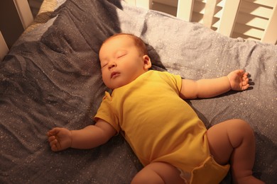 Photo of Cute newborn baby sleeping in crib indoors