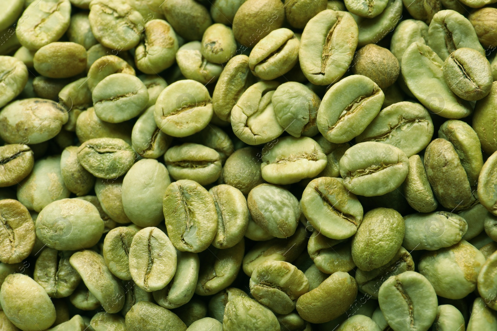 Photo of Many green coffee beans as background, top view