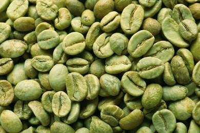 Photo of Many green coffee beans as background, top view