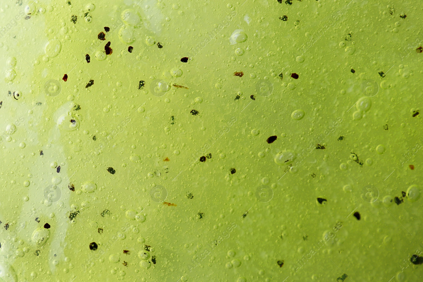 Photo of Texture of yellow shower gel as background, closeup