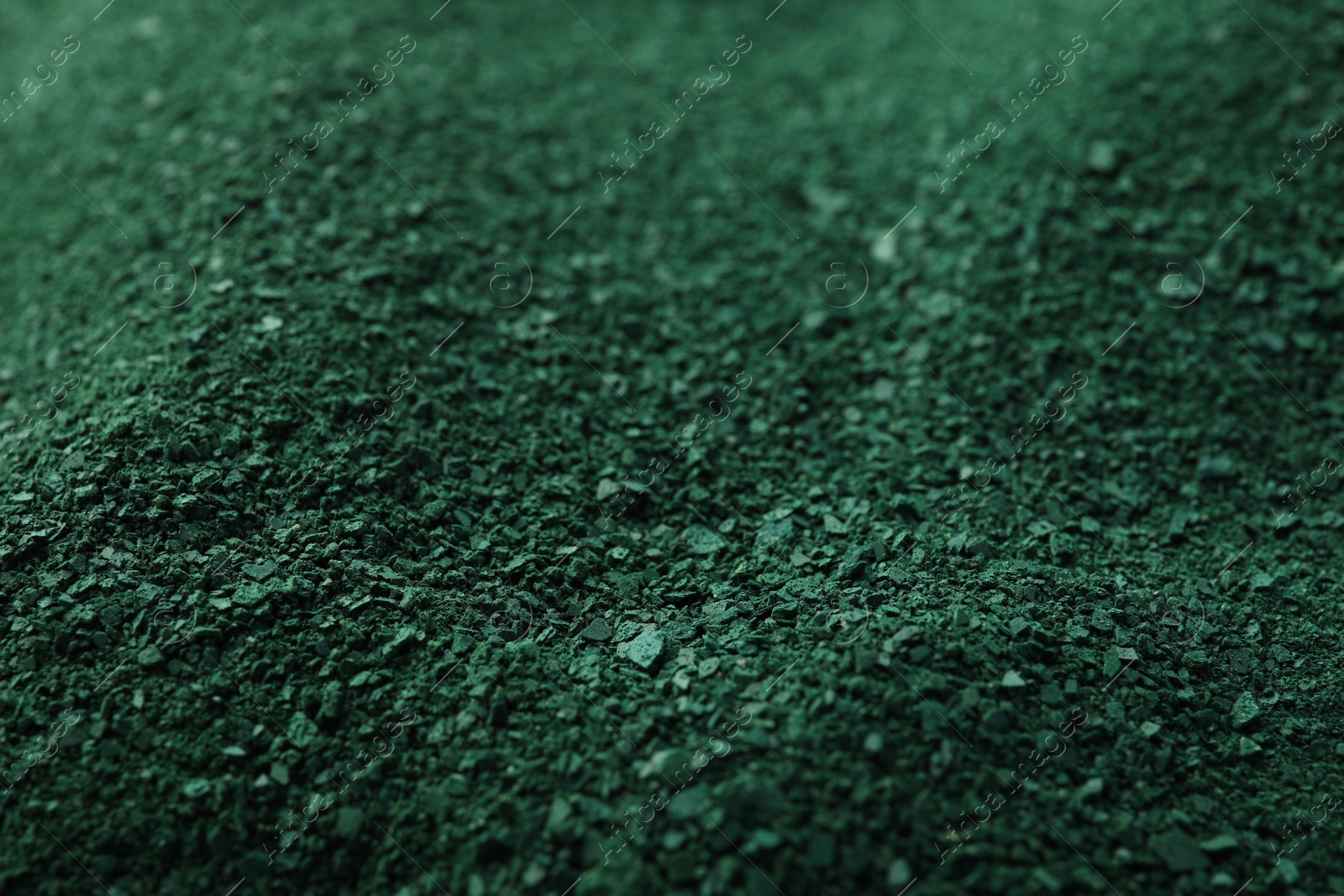 Photo of Green spirulina algae powder as background, closeup