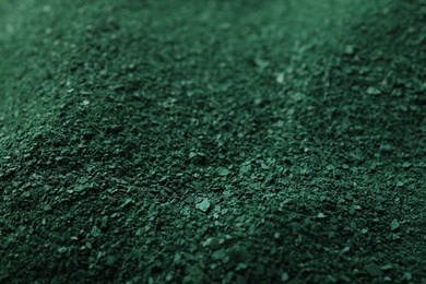 Green spirulina algae powder as background, closeup