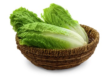 Fresh tasty Chinese cabbages in wicker basket on white background