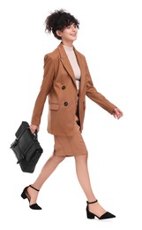 Beautiful businesswoman in suit with briefcase walking on white background