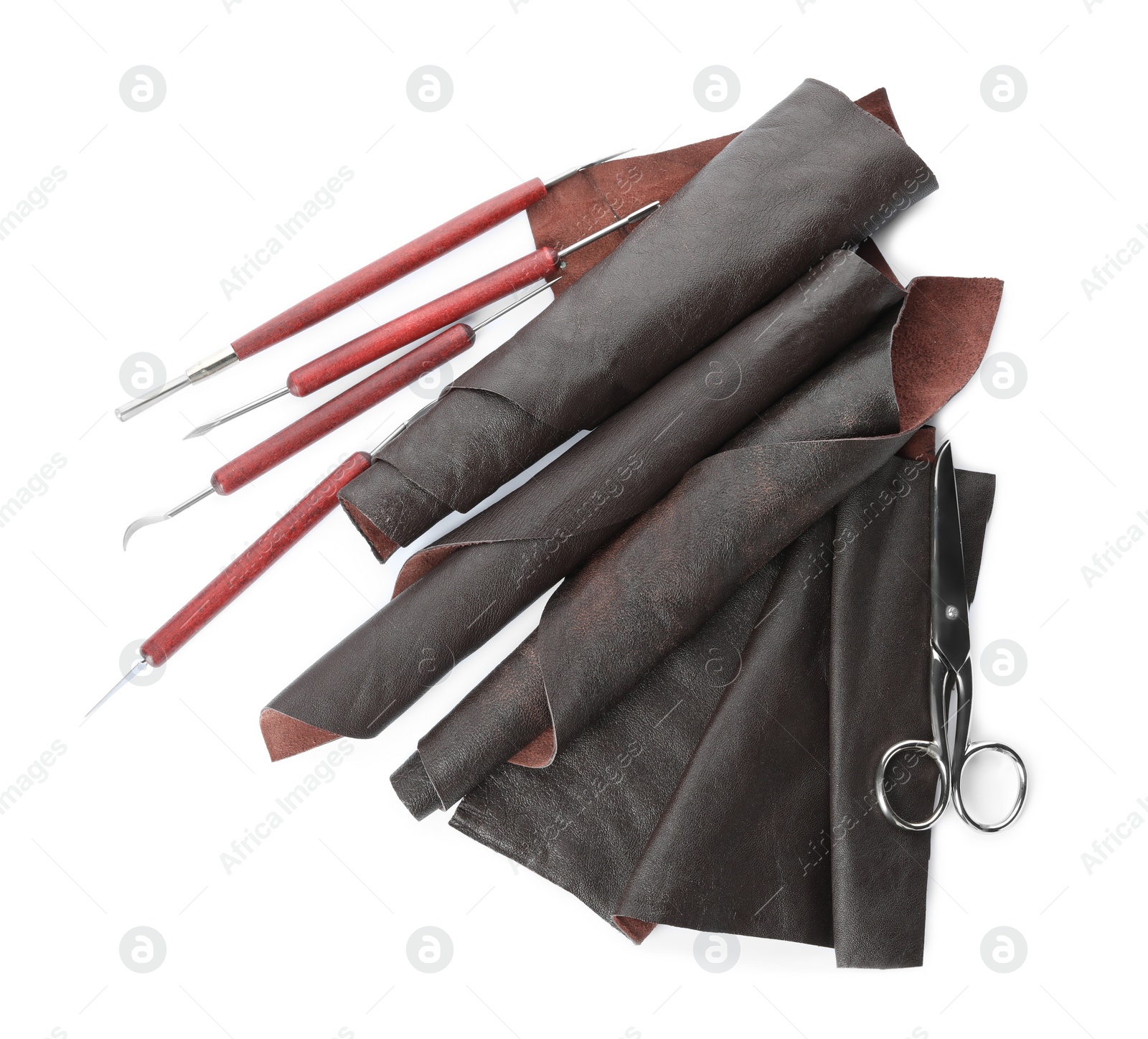 Photo of Leather samples and craftsman tools isolated on white, top view