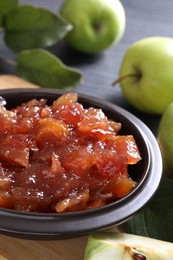 Photo of Bowl of delicious apple jam and fresh fruits on table, closeup. Space for text