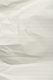 Crumpled lined notebook sheet as background, top view