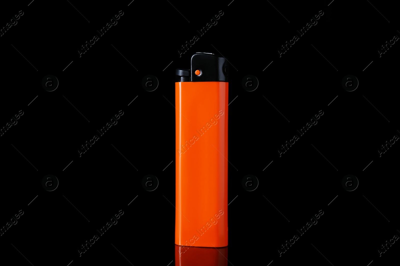 Photo of Orange plastic cigarette lighter on black background, closeup