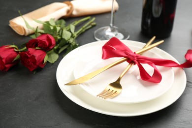 Photo of Beautiful table setting for Valentine's Day dinner on black background, closeup