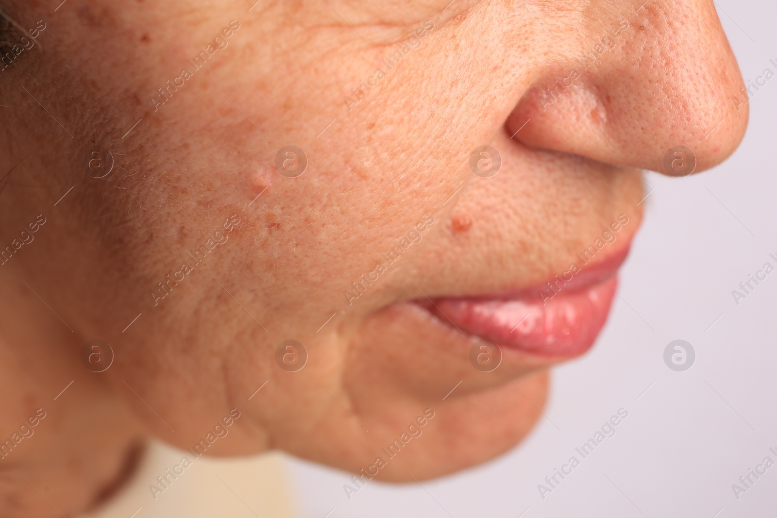 Photo of Closeup view of older woman on white background