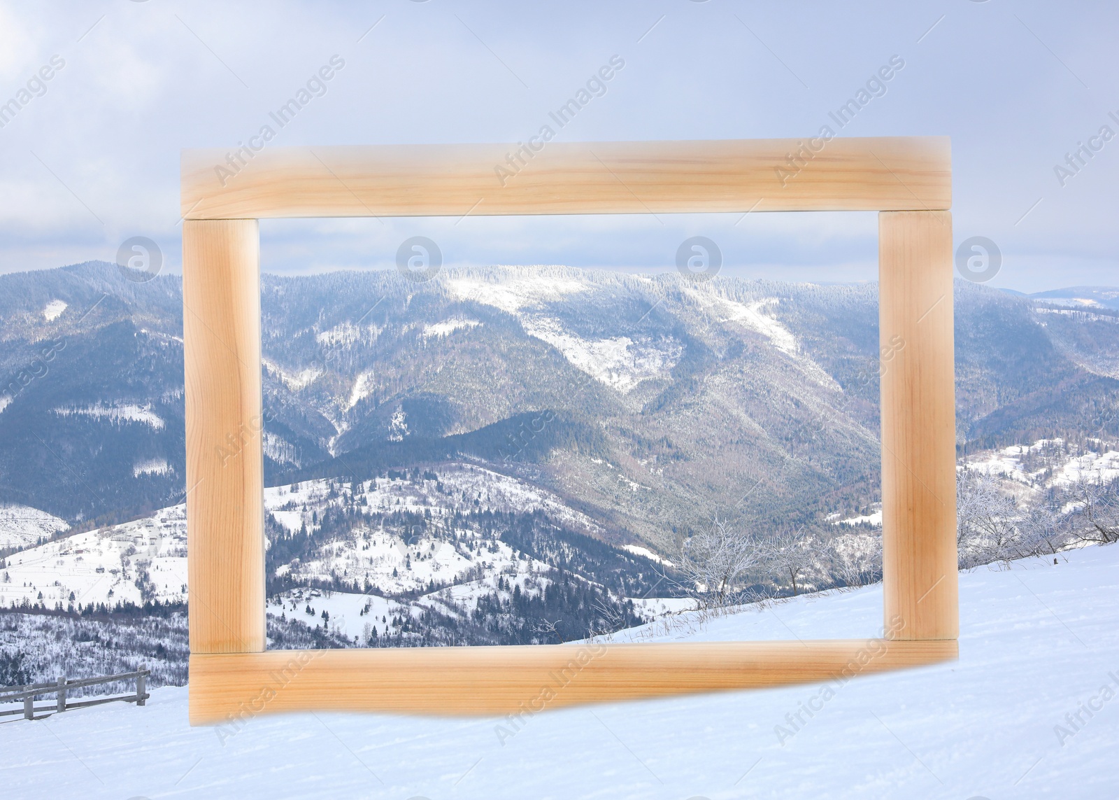 Image of Wooden frame and beautiful mountains covered with snow in winter