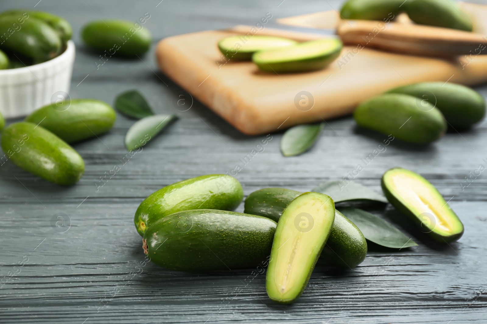 Photo of Fresh seedless avocados on grey wooden table