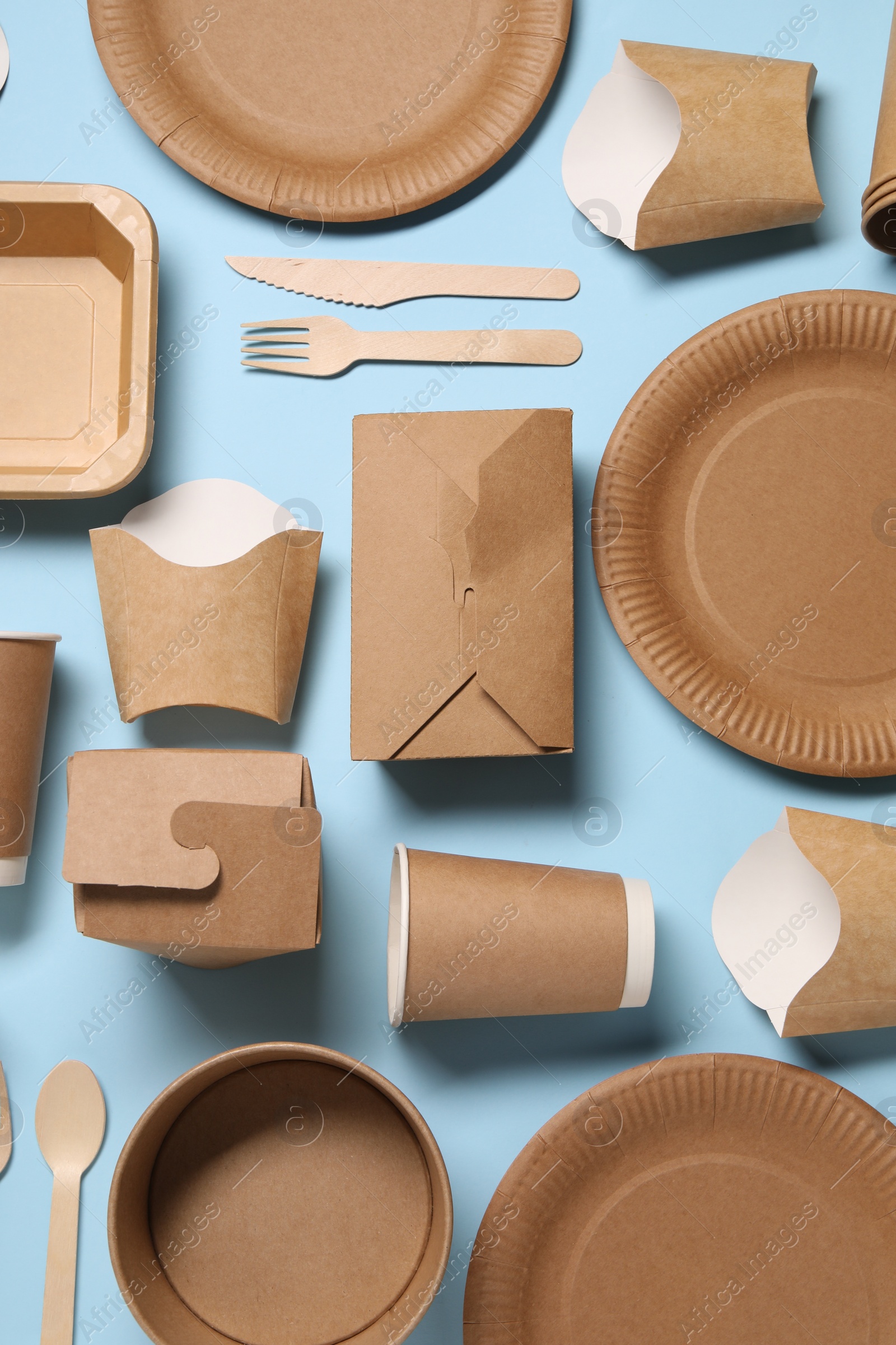 Photo of Flat lay composition with eco friendly food packagings on light blue background