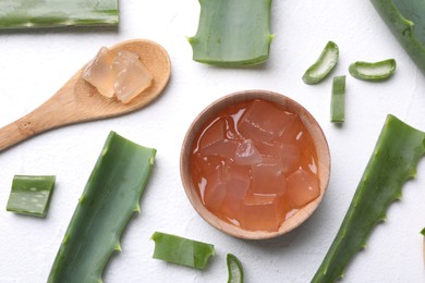 Flat lay composition with aloe vera gel and slices of plant on white background