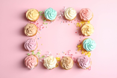 Photo of Flat lay composition with delicious birthday cupcakes and space for text on color background