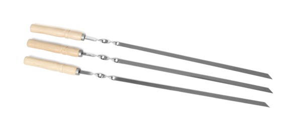 Metal skewers with wooden handle on white background, top view