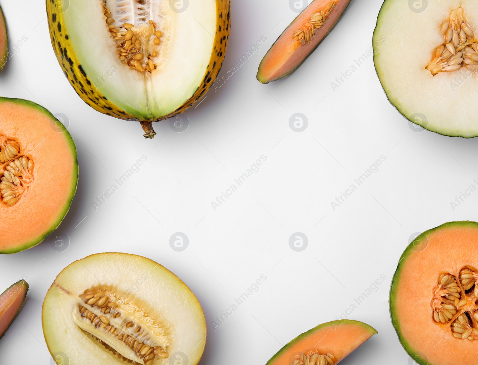 Cut different types of melons on white background, flat lay. Space for text Photo of Cut different types of melons on white background, flat lay. Space for text