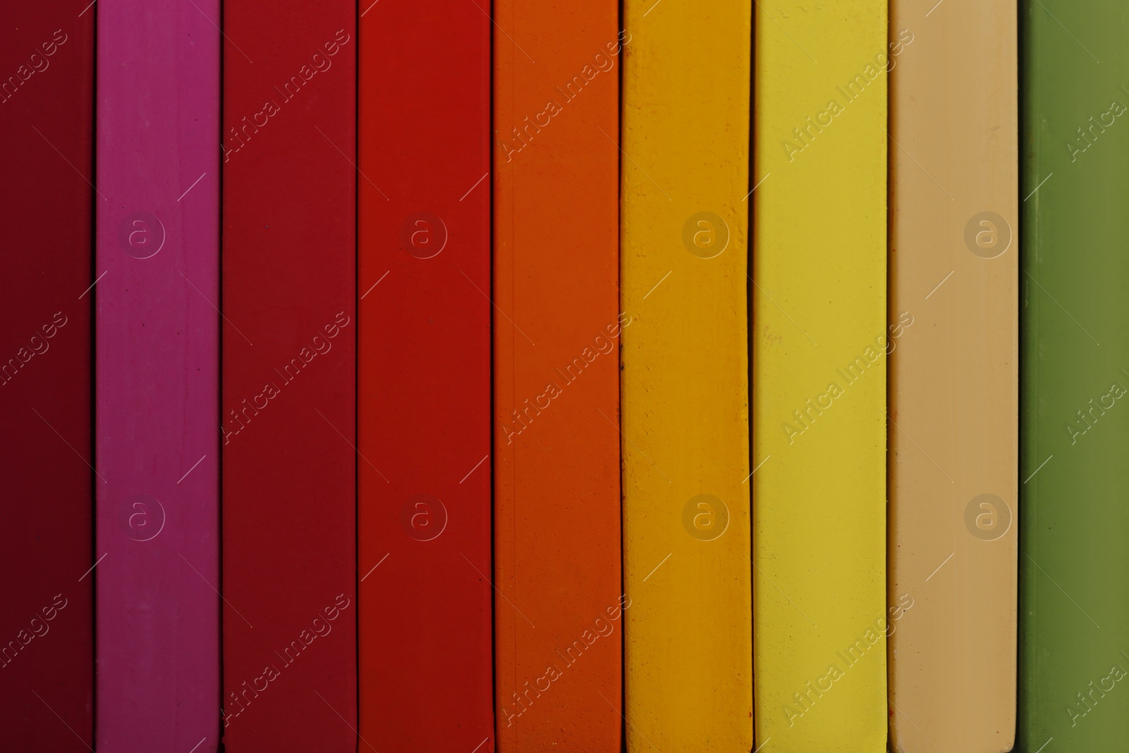 Photo of Set of colorful pastels as background, closeup. Drawing materials