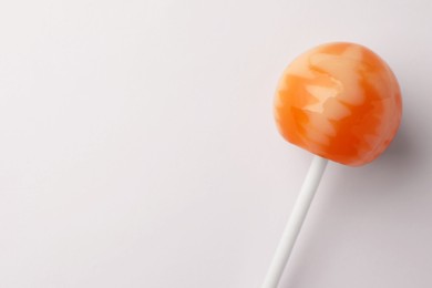 Tasty lollipop on white background, top view. Space for text