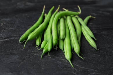 Fresh green beans on black table, closeup