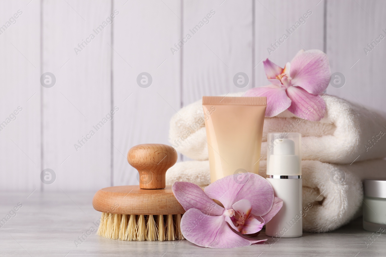 Photo of Beautiful composition with different spa products on light gray table. Space for text