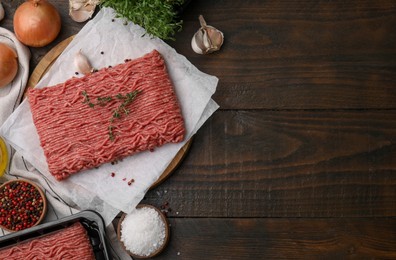 Photo of Flat lay composition with fresh raw ground meat on wooden table. Space for text