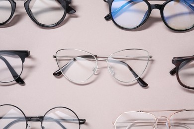 Many different stylish glasses on light grey background, flat lay