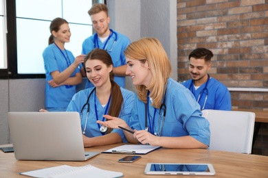 Photo of Medical students in uniforms studying at university