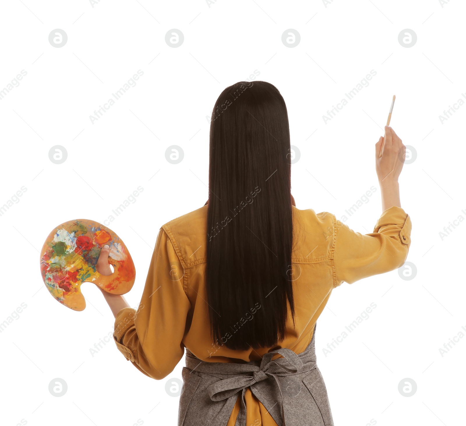 Photo of Young woman drawing with brush on white background, back view