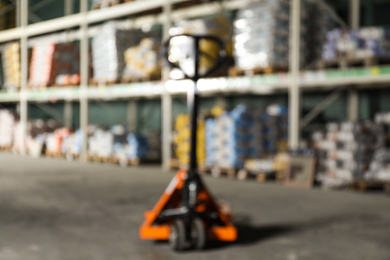 Blurred view of manual pallet truck in wholesale warehouse