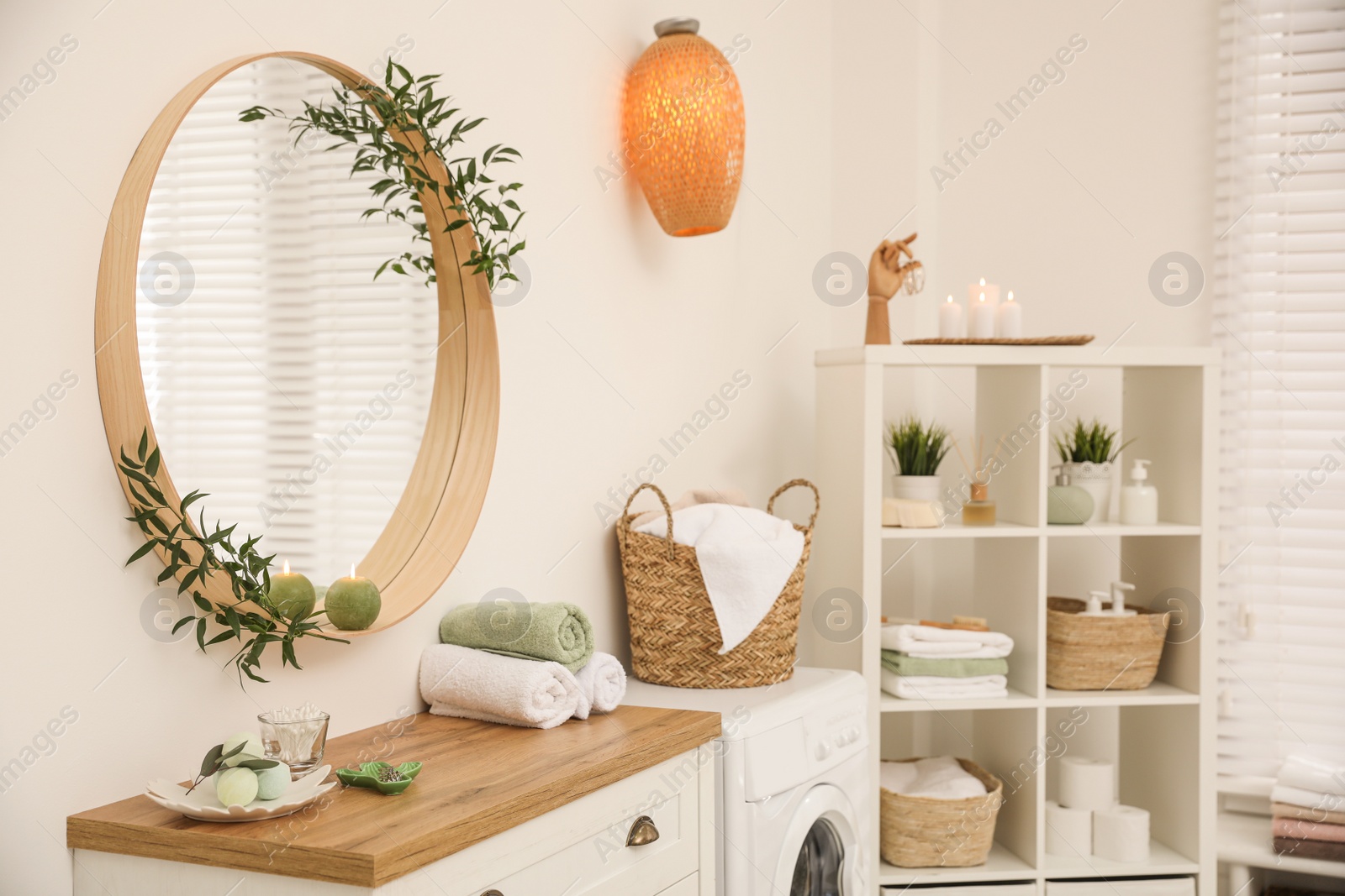 Photo of Round mirror on white wall in modern bathroom