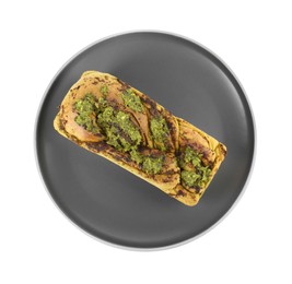 Photo of Plate with freshly baked pesto bread isolated on white, top view