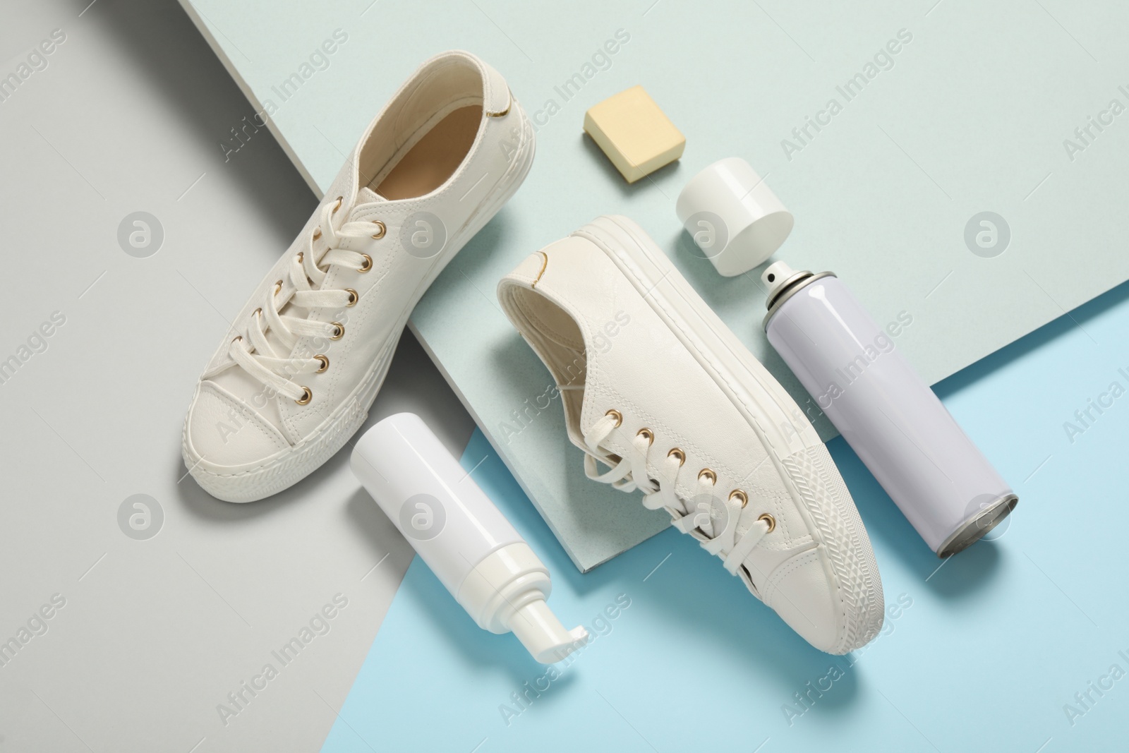 Photo of Composition with stylish footwear and shoe care accessories on color background, above view