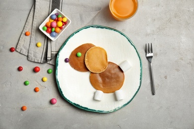 Funny pancakes for kids breakfast on table, top view