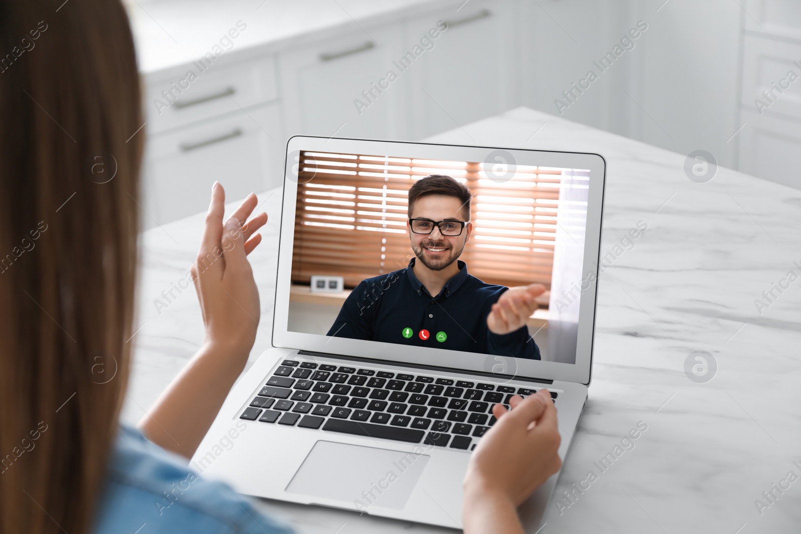 Image of Woman talking with handsome man using video chat on laptop at white marble table, closeup. Online dating