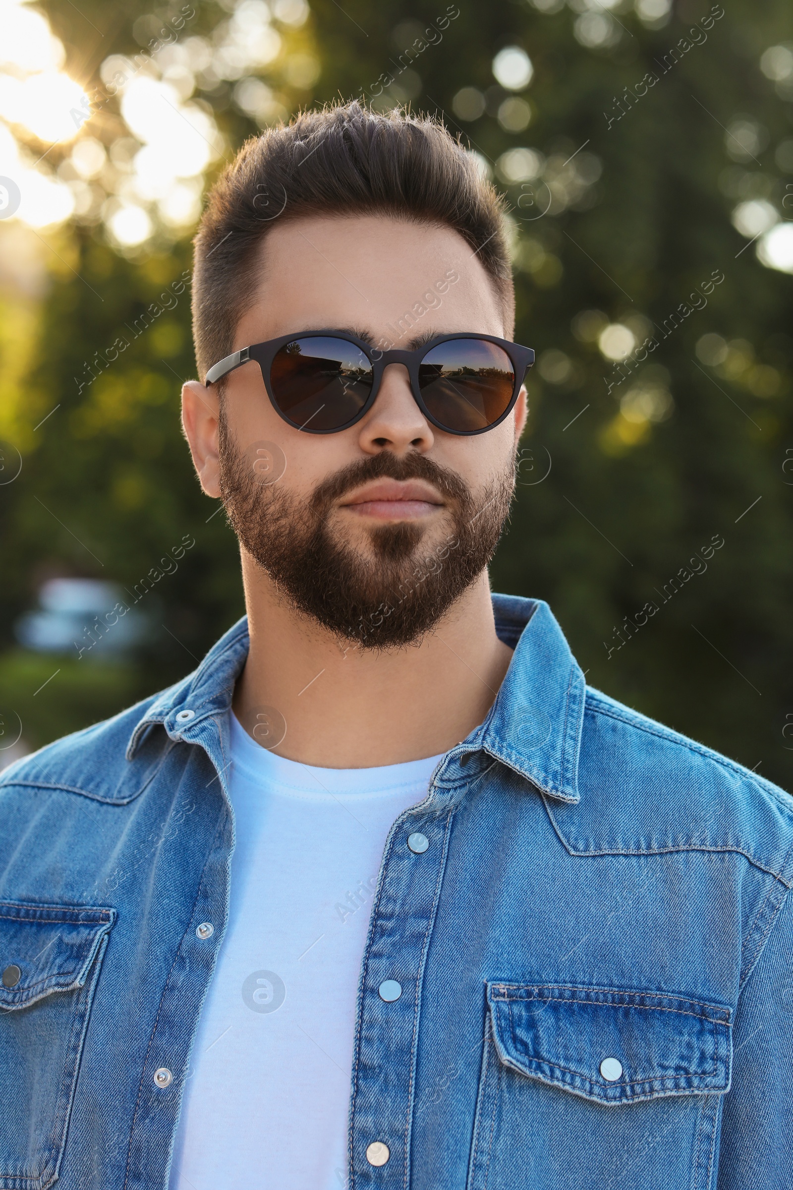 Photo of Handsome man in sunglasses outdoors on summer day