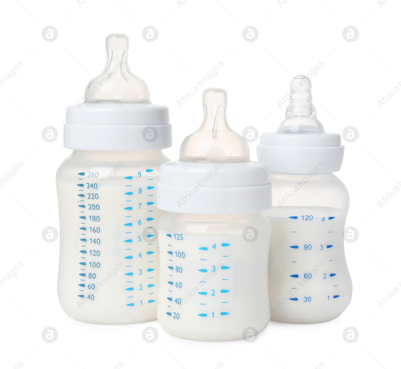 Photo of Three feeding bottles with milk on white background