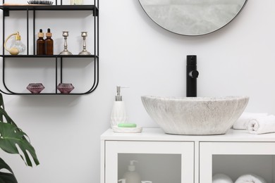 Photo of Different bath accessories, personal care products and bathroom vanity indoors