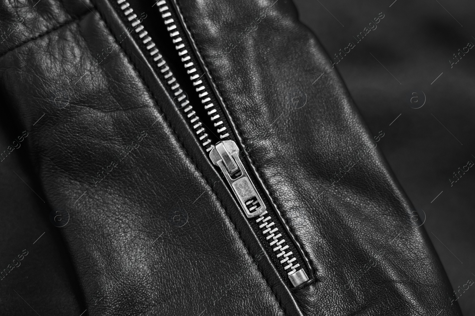 Photo of Texture of black leather jacket with zipper as background, top view