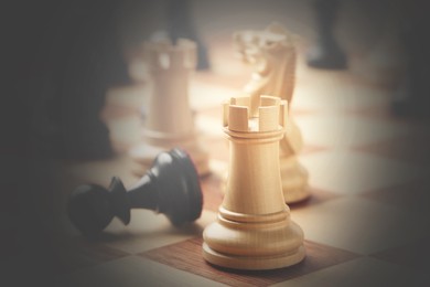 Image of Chessboard with game pieces, closeup. Vignette effect
