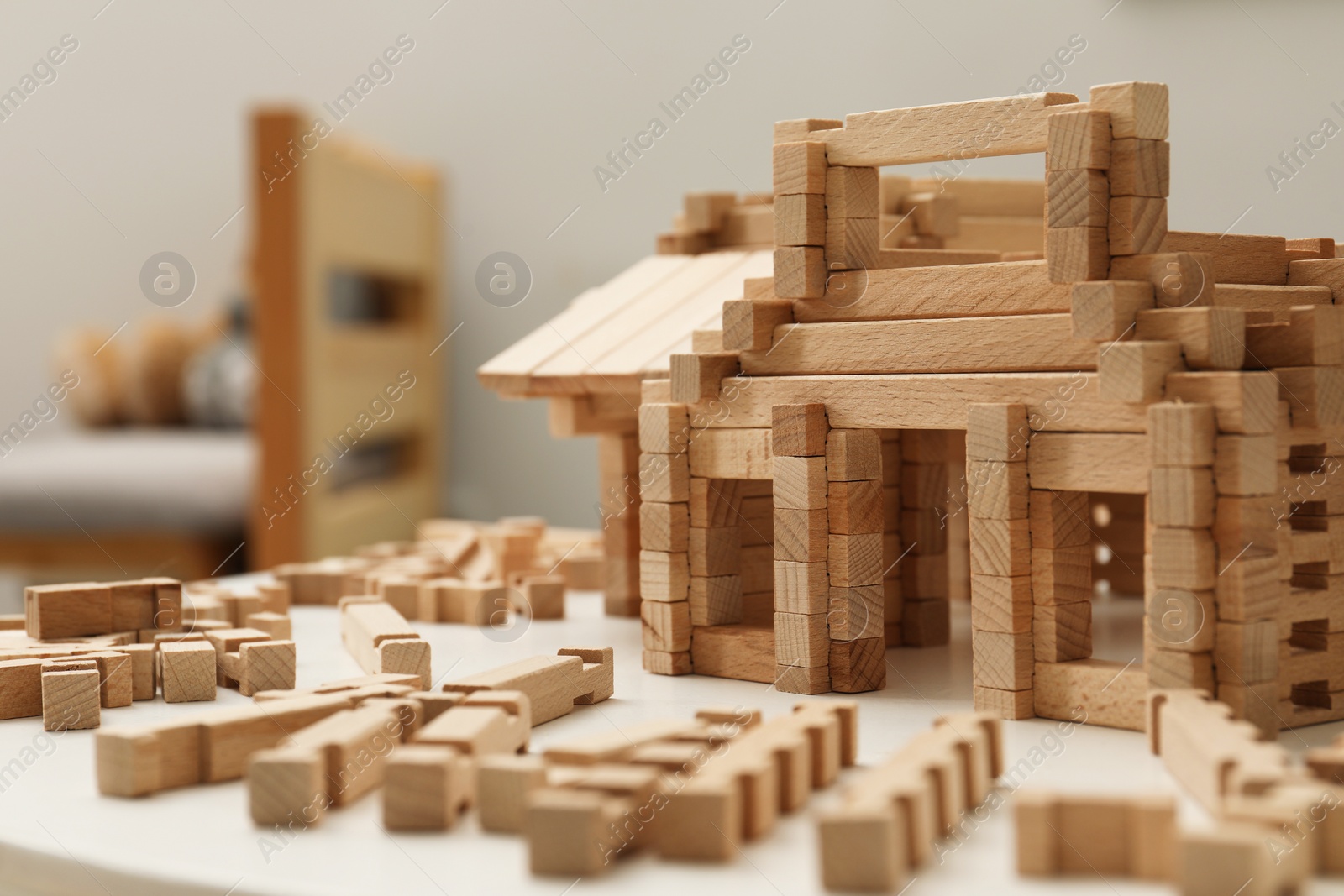 Photo of Wooden construction set on white table indoors, closeup. Children's toy