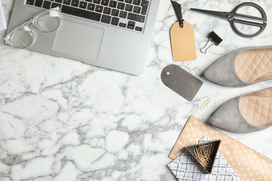 Photo of Flat lay composition with stylish shoes, laptop and space for text on marble background. Fashion blogger