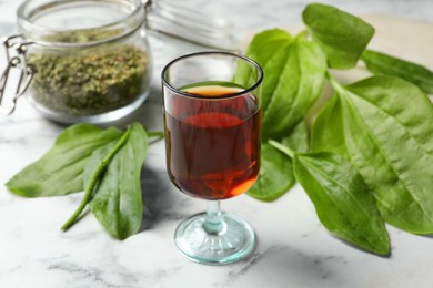 Photo of Broadleaf plantain tincture on white marble table