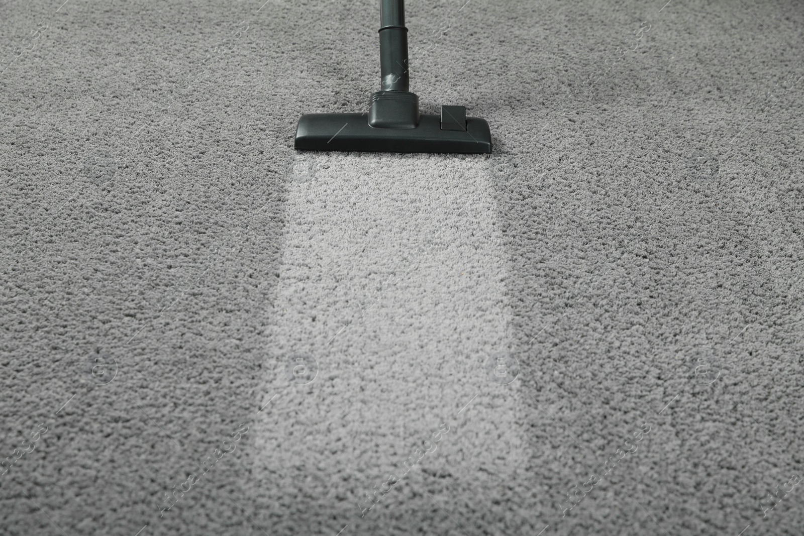 Photo of Vacuuming grey carpet. Clean area after using device. Space for text