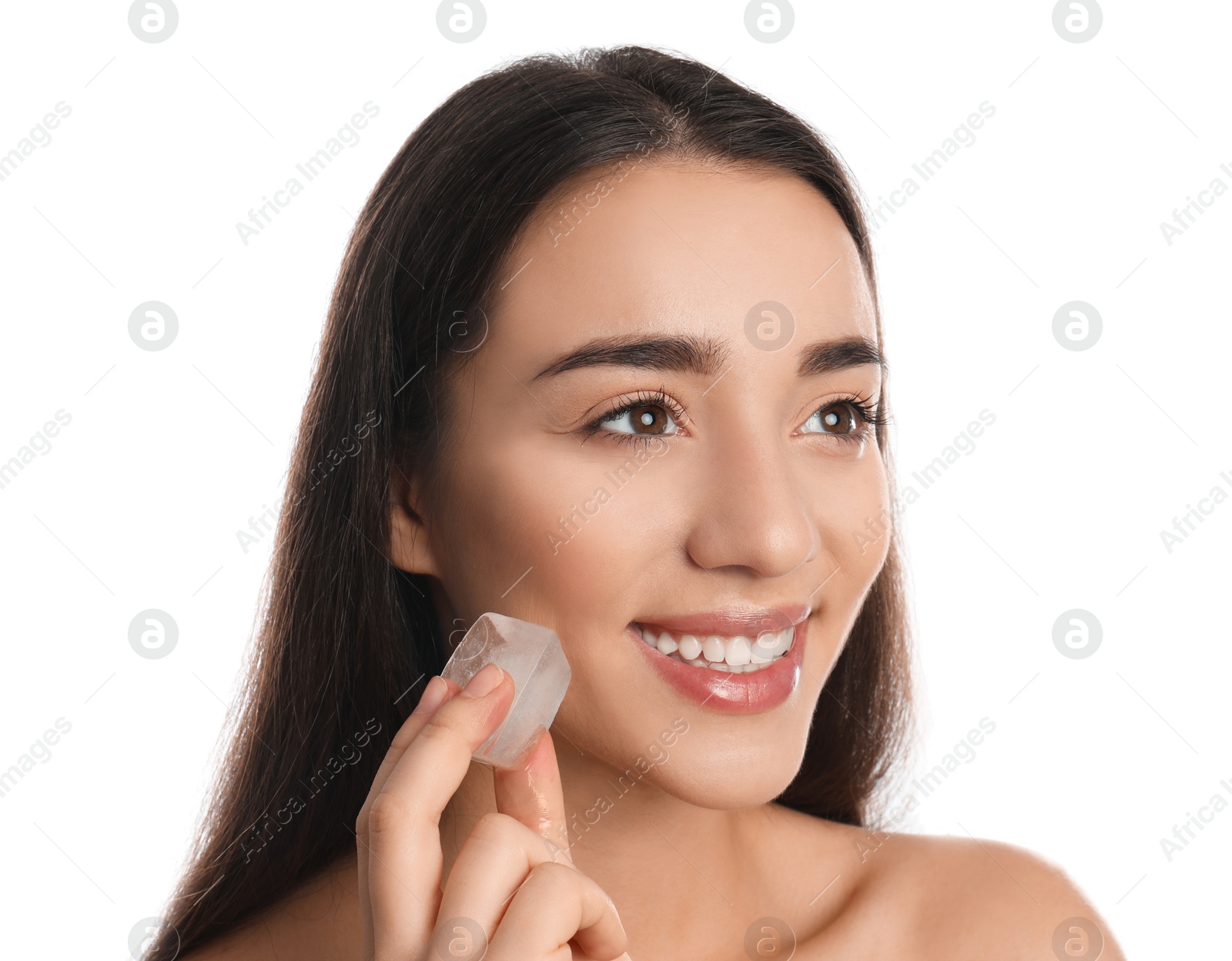 Photo of Young woman with ice cube on white background. Skin care