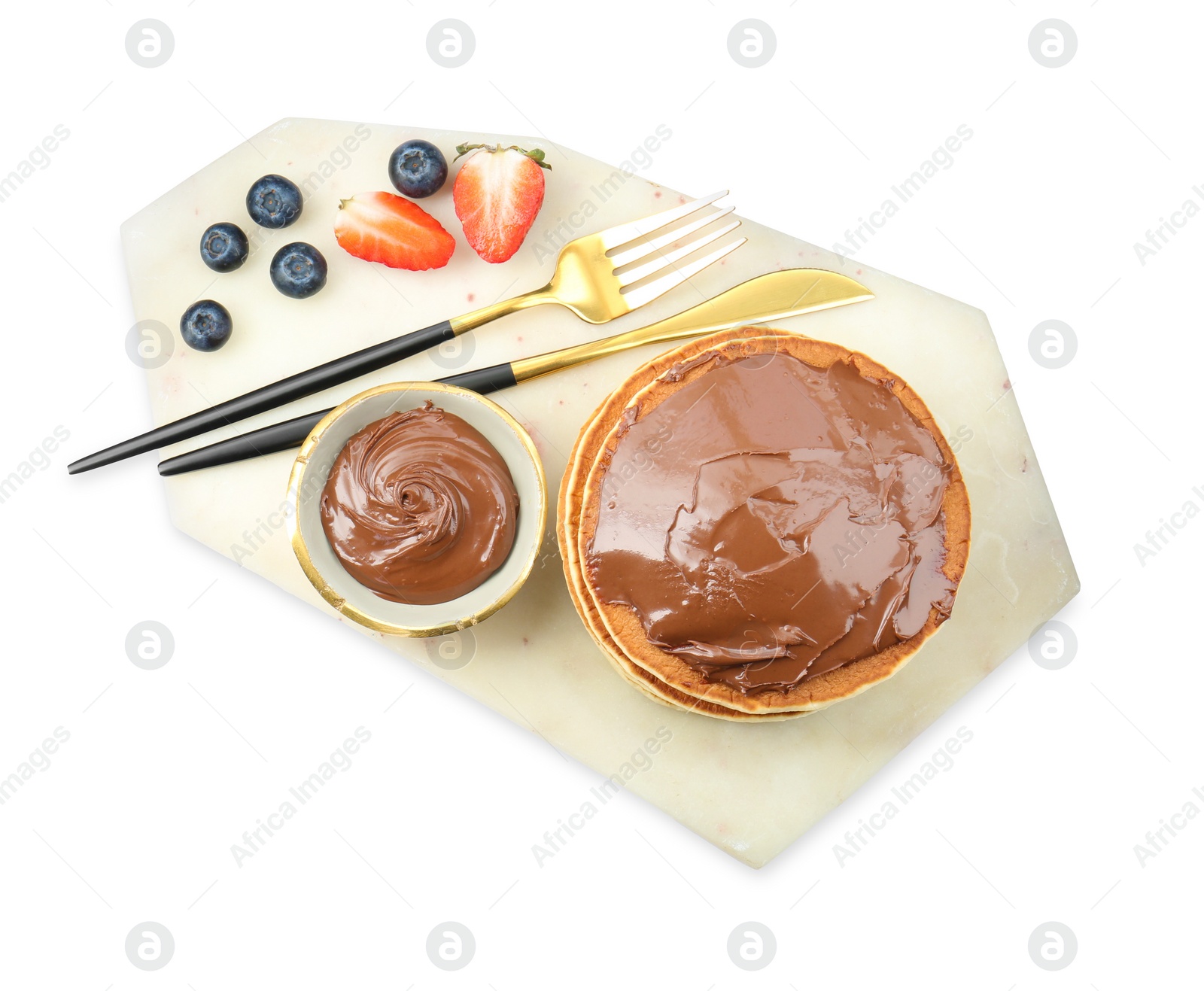 Photo of Delicious pancakes with chocolate paste, berries and cutlery isolated on white, top view