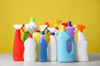 Photo of Bottles of different cleaning products on light table