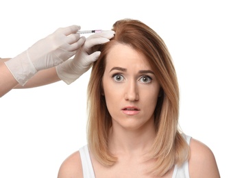 Young woman with hair loss problem receiving injection, on white background