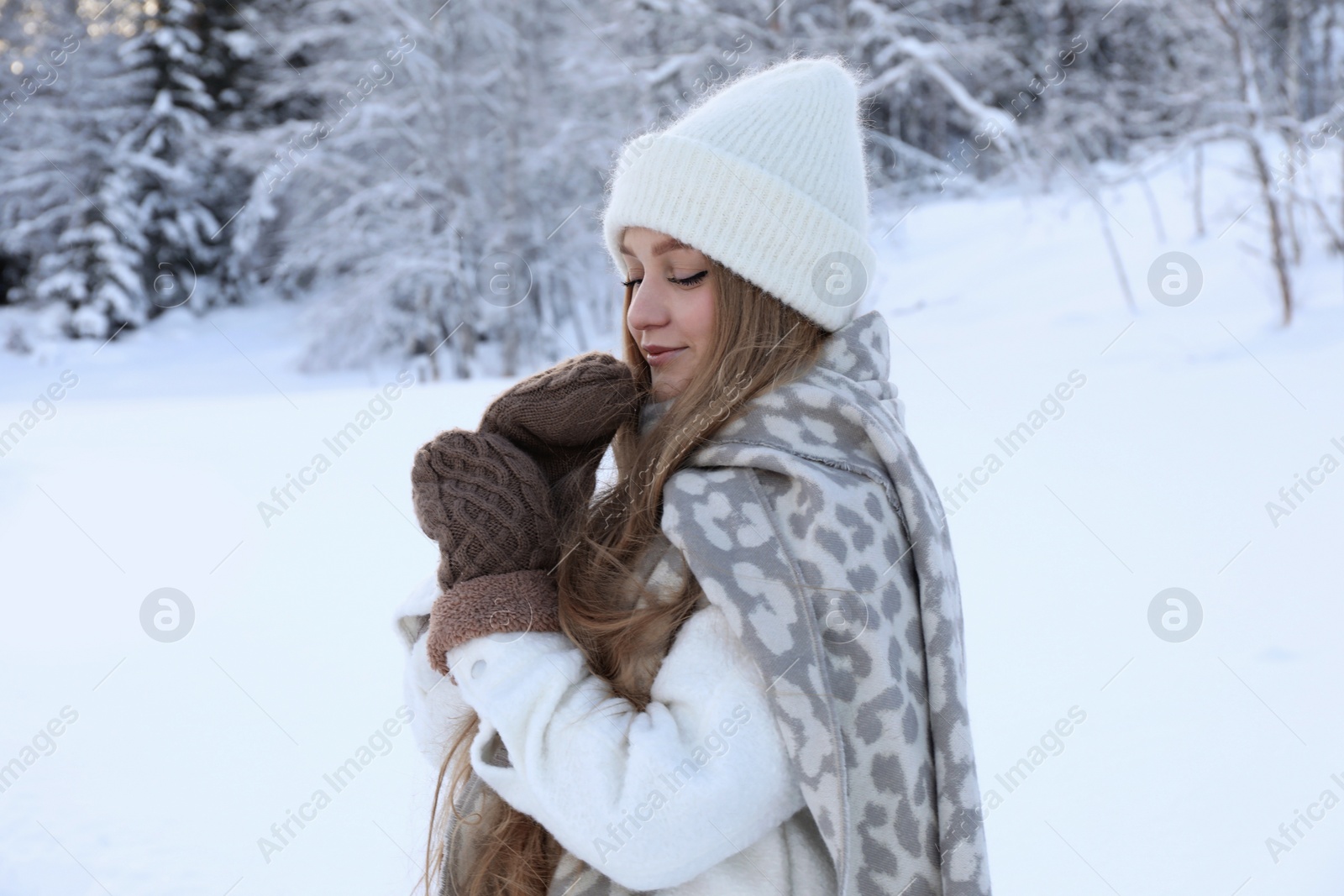 Photo of Winter vacation. Beautiful woman near snowy forest outdoors